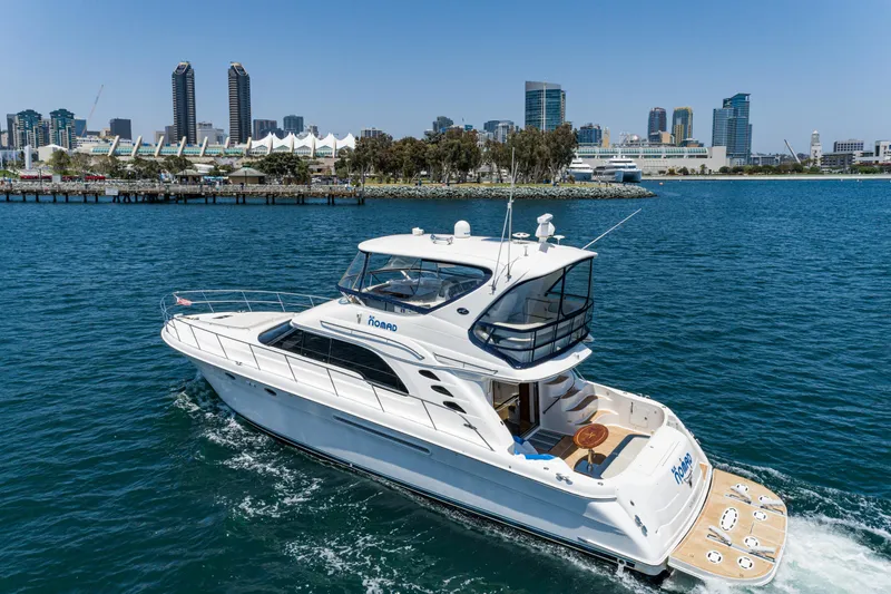 Slide: The Image of 2001 Sea Ray 560 Sedan Bridge yacht cruising in a city harbor. - 10