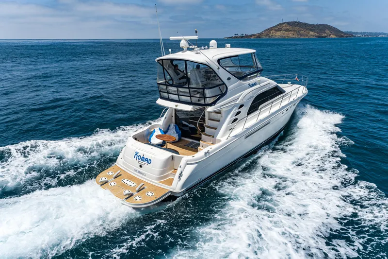 Slide: The Image of 2001 Sea Ray 560 Sedan Bridge yacht cruising on open water. - 13