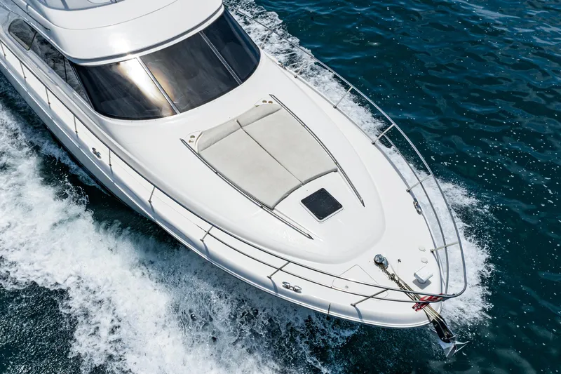 Slide: The Image of 2001 Sea Ray 560 Sedan Bridge yacht cruising on open water. - 17