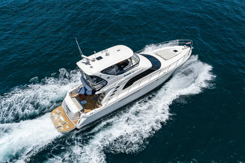 Slide: The Image of 2001 Sea Ray 560 Sedan Bridge yacht cruising on open water. - 19