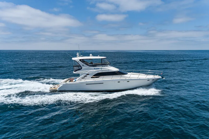 Slide: The Image of 2001 Sea Ray 560 Sedan Bridge cruising on open ocean under blue sky. - 21