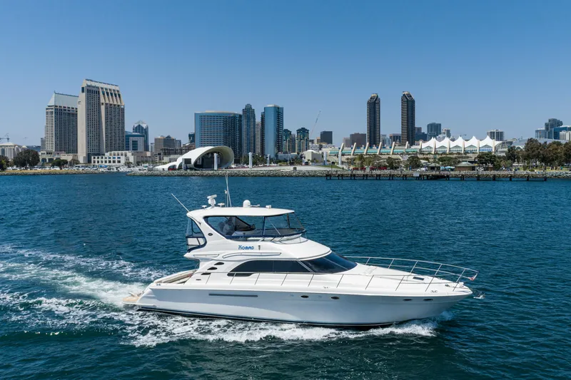 Slide: The Image of 2001 Sea Ray 560 Sedan Bridge yacht cruising near city skyline. - 23