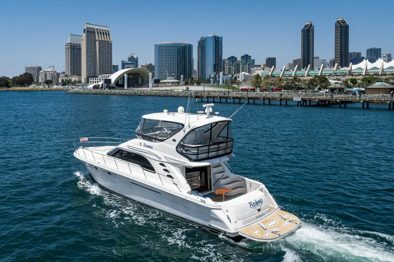 Slide: The Image of 2001 Sea Ray 560 Sedan Bridge yacht cruising near city skyline. - 30