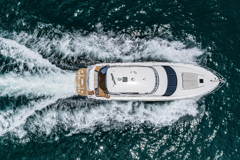 Slide: The Image of Aerial view of 2001 Sea Ray 560 Sedan Bridge yacht cruising on open water. - 31
