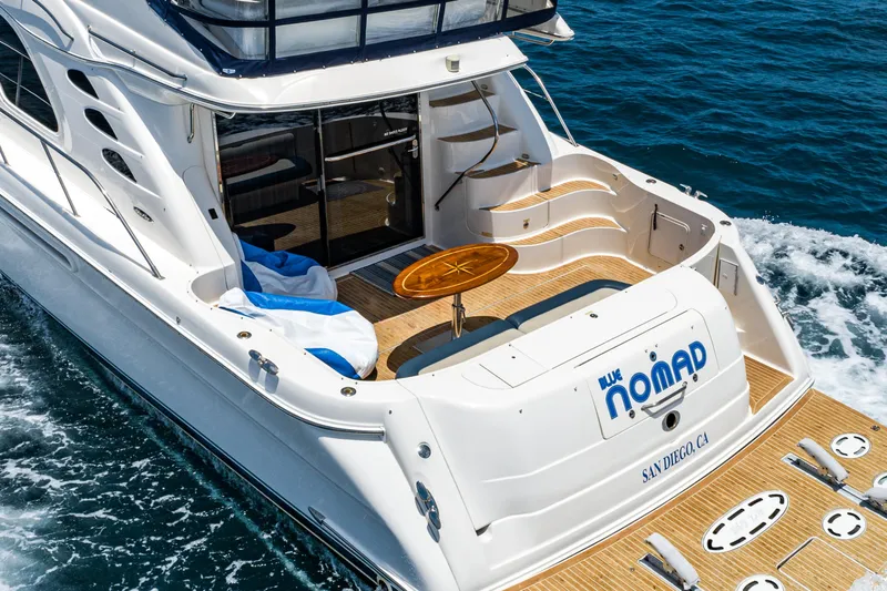 Slide: The Image of 2001 Sea Ray 560 Sedan Bridge yacht cruising on open water. - 33