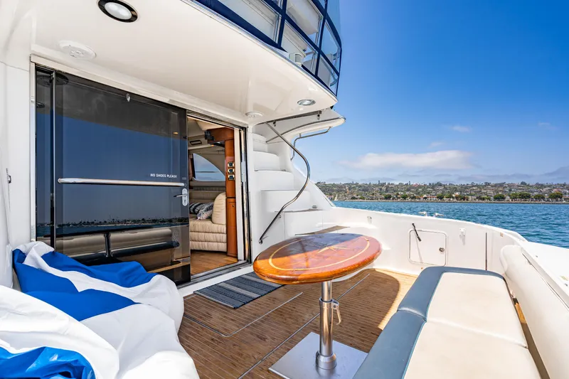 Slide: The Image of 2001 Sea Ray 560 Sedan Bridge yacht deck with seating and ocean view. - 35