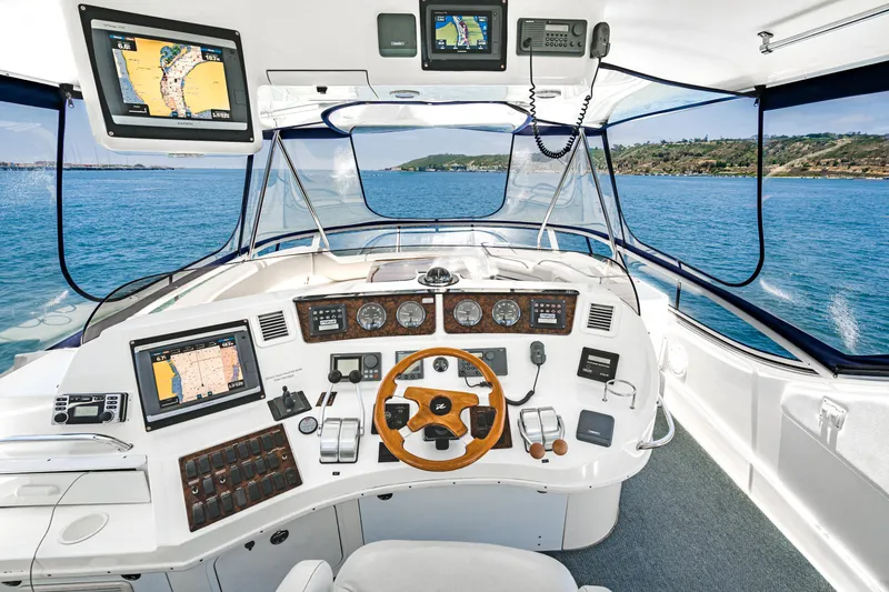 Slide: The Image of Cockpit of 2001 Sea Ray 560 Sedan Bridge with navigation screens and steering wheel. - 38
