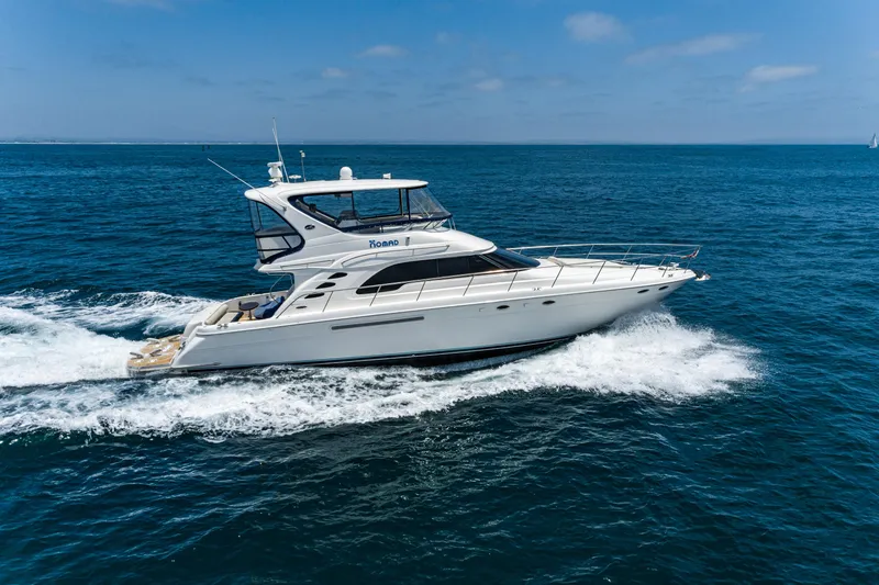 Slide: The Image of 2001 Sea Ray 560 Sedan Bridge yacht cruising on open water. - 4