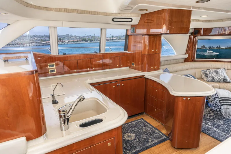 Slide: The Image of Luxurious interior of 2001 Sea Ray 560 Sedan Bridge yacht with elegant wood finishes. - 46