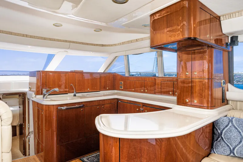 Slide: The Image of Luxurious kitchen interior of 2001 Sea Ray 560 Sedan Bridge yacht with wooden cabinetry. - 47