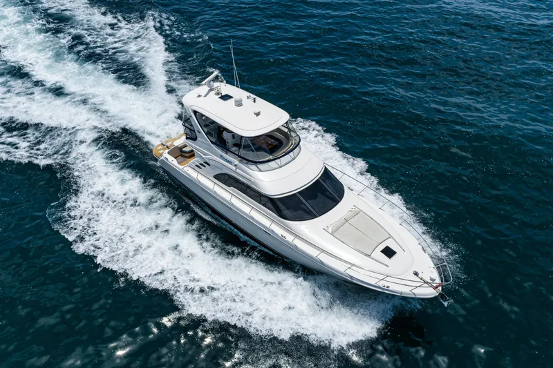 Slide: The Image of 2001 Sea Ray 560 Sedan Bridge yacht cruising on open water. - 7