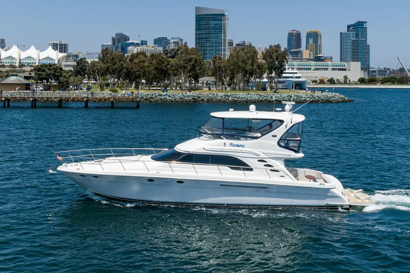 Slide: The Image of 2001 Sea Ray 560 Sedan Bridge yacht cruising near city skyline. - 8