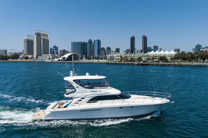 Slide: The Image of 2001 Sea Ray 560 Sedan Bridge yacht cruising near city skyline on a sunny day. - 9