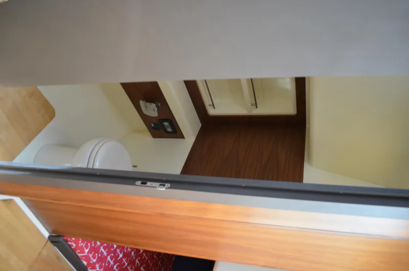 Slide: The Image of Interior of 2016 Chris-Craft Launch 36, featuring a compact bathroom with wooden accents. - 15