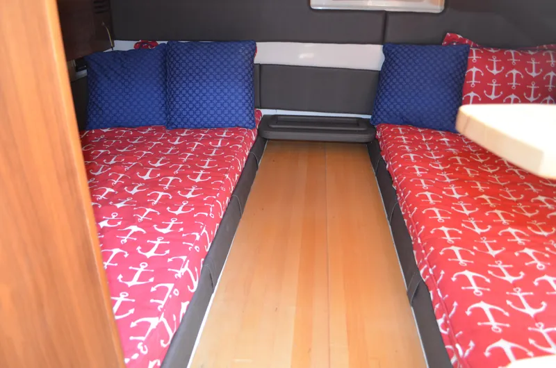 Slide: The Image of 2016 Chris-Craft Launch 36 cabin with nautical-themed bedding and wooden flooring. - 17
