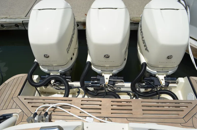 Slide: The Image of Triple Mercury outboard engines on a 2016 Chris-Craft Launch 36 boat at a dock. - 18