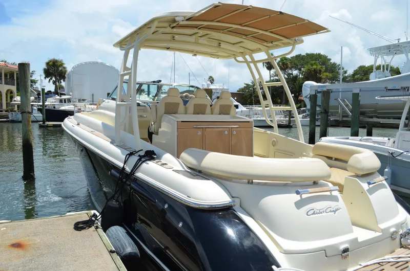 Slide: The Image of 2016 Chris-Craft Launch 36 boat docked at marina, featuring elegant design and spacious seating. - 19