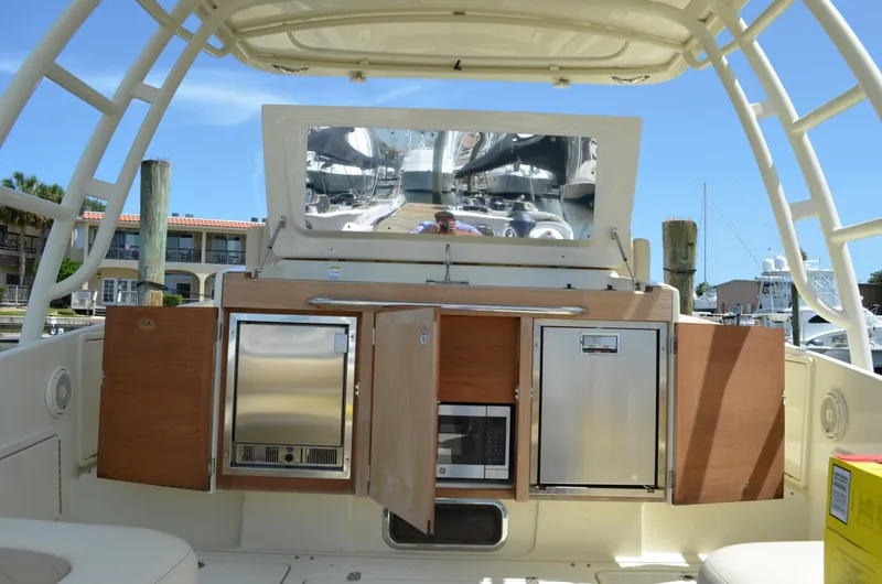 Slide: The Image of 2016 Chris-Craft Launch 36 boat interior with open cabinets and appliances. - 2