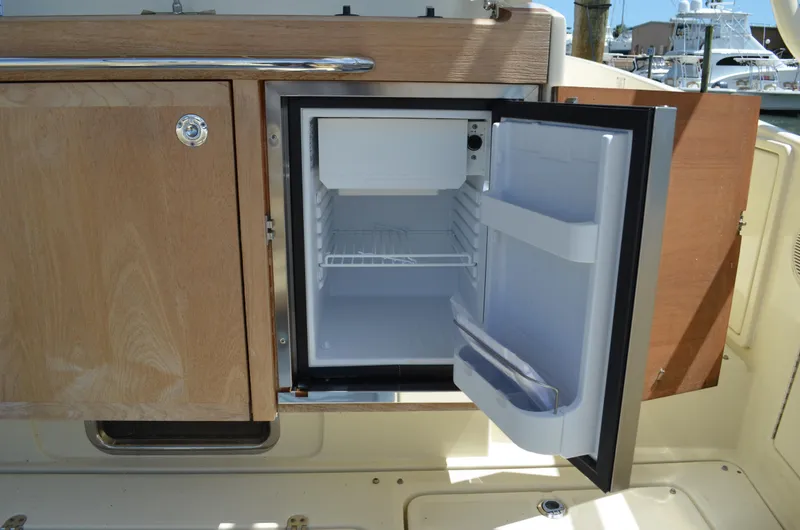 Slide: The Image of Open mini fridge on 2016 Chris-Craft Launch 36 boat, showcasing interior storage space. - 26