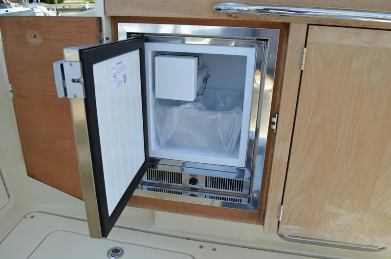 Slide: The Image of 2016 Chris-Craft Launch 36 boat interior with open mini fridge. - 28