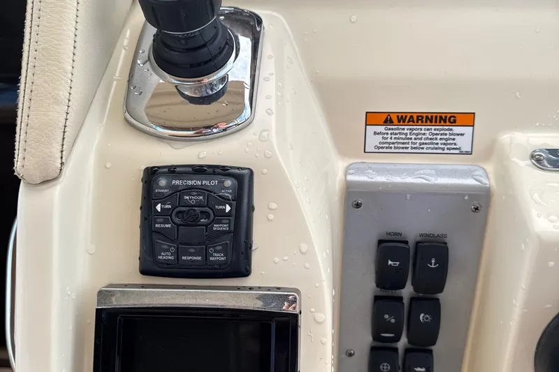 Slide: The Image of Control panel of 2016 Chris-Craft Launch 36 boat with warning label and buttons. - 37