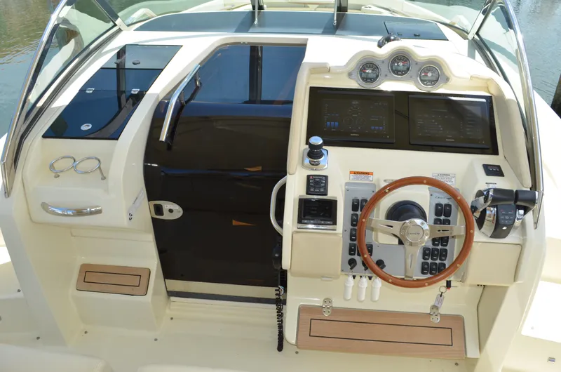 Slide: The Image of 2016 Chris-Craft Launch 36 dashboard with steering wheel and navigation controls. - 4