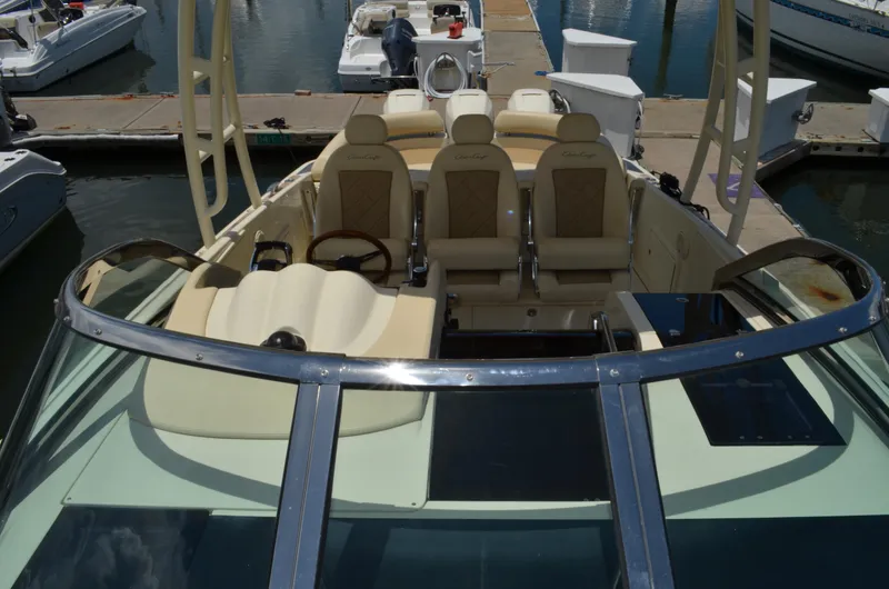 Slide: The Image of 2016 Chris-Craft Launch 36 boat interior with luxurious seating at a marina. - 5
