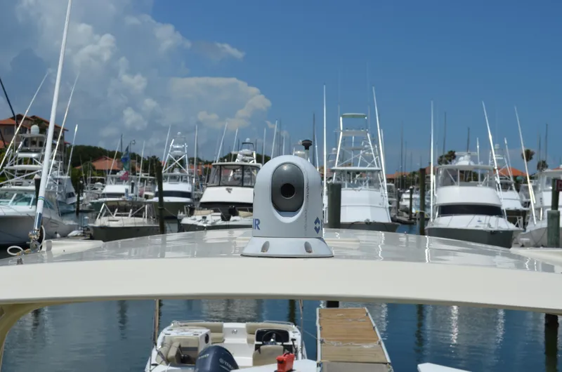 Slide: The Image of 2016 Chris-Craft Launch 36 at marina, surrounded by various boats under a clear blue sky. - 6