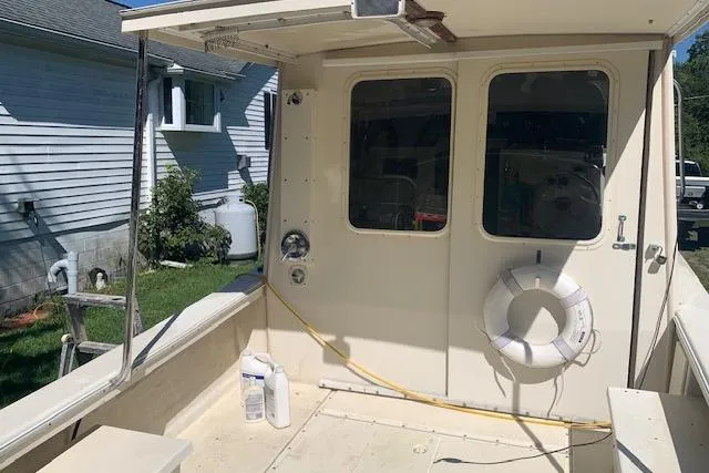 Slide: The Image of 2002 Rosborough RF-246 Custom Wheelhouse boat with life preserver and cleaning supplies on deck. - 15