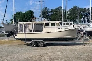 Slide: The Image of 2002 Rosborough RF-246 Custom Wheelhouse boat on stands, parked outdoors. - 2