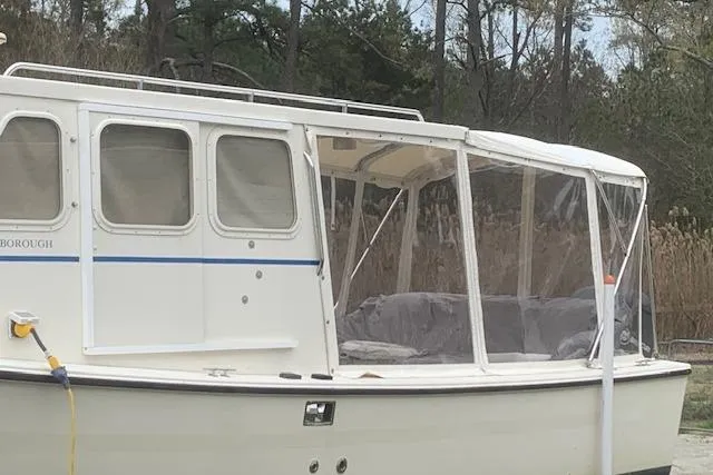 Slide: The Image of 2002 Rosborough RF-246 Custom Wheelhouse boat on trailer, surrounded by trees. - 3