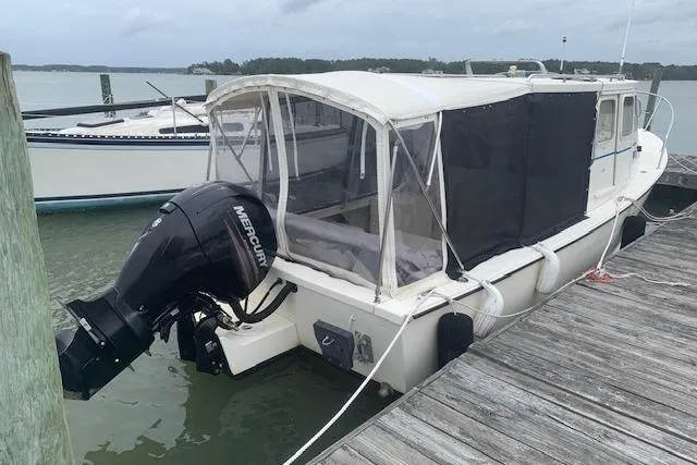 Slide: The Image of 2002 Rosborough RF-246 Custom Wheelhouse boat on trailer, parked in a marina. - 4