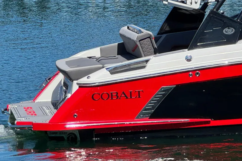 Slide: The Image of 2023 Cobalt R4 Surf boat in vibrant red on water, showcasing sleek design. - 2