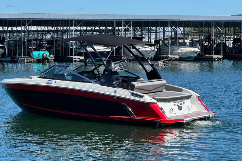 Slide: The Image of 2023 Cobalt R4 Surf boat in marina, featuring sleek design and vibrant colors. - 4