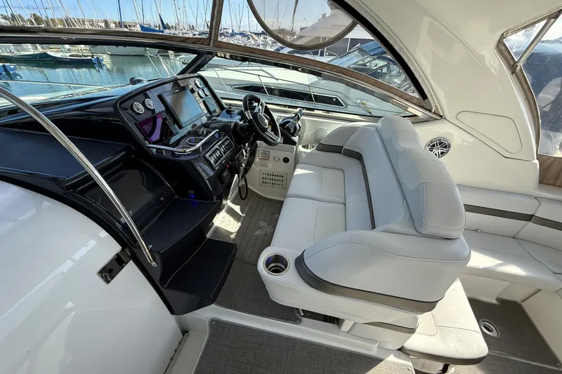 Slide: The Image of 2018 Formula 37 Performance Cruiser interior with beige leather seating and decorative pillows. - 17