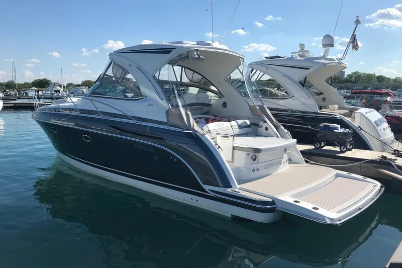 Slide: The Image of 2018 Formula 37 Performance Cruiser interior with white seating and modern dashboard. - 2