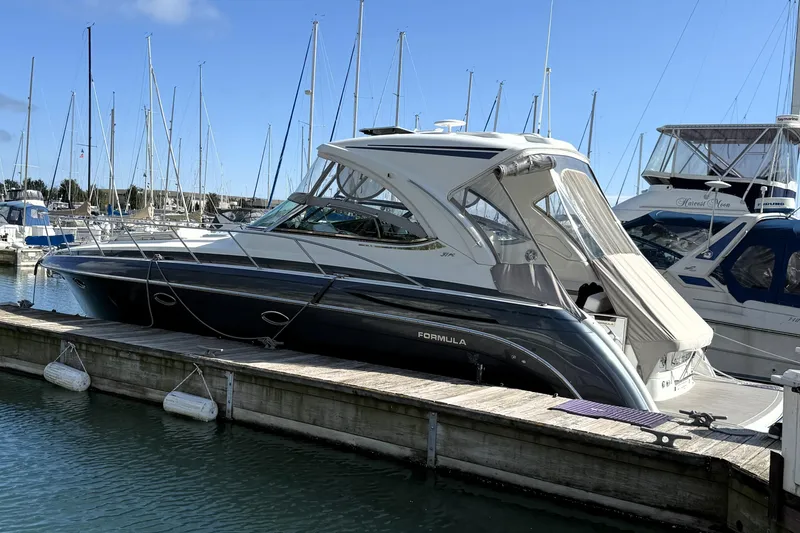 Slide: The Image of 2018 Formula 37 Performance Cruiser docked at a marina, featuring sleek design and modern amenities. - 6