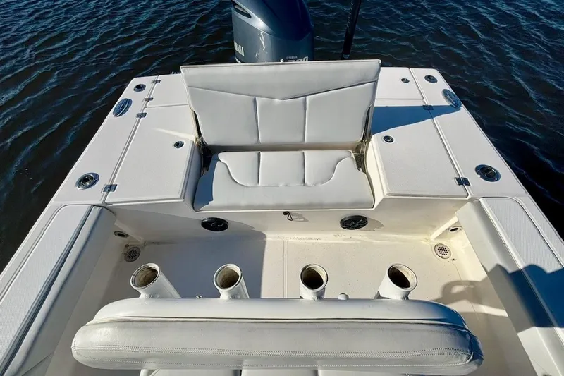 Slide: The Image of 2017 Robalo 246 Cayman boat interior with white seating and rod holders. - 13