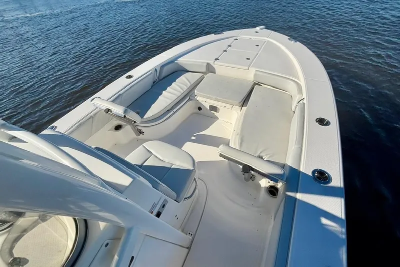 Slide: The Image of 2017 Robalo 246 Cayman boat interior with seating, on calm water. - 8