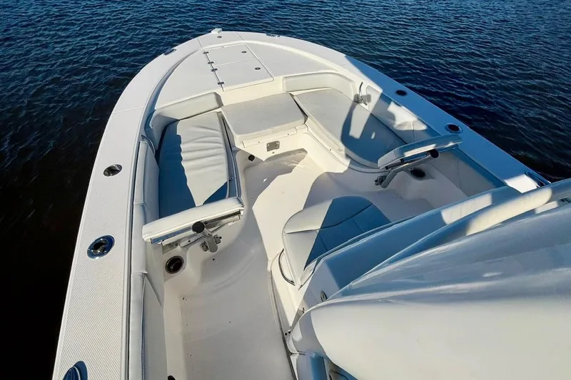 Slide: The Image of 2017 Robalo 246 Cayman boat interior with seating, on calm water. - 9