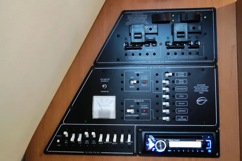Slide: The Image of Electrical control panel, featuring switches and a Sony audio system. - 10