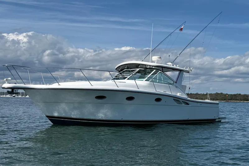 The Image of 2003 Tiara Yachts 3500 Open cruising on calm waters under a clear blue sky. - 0