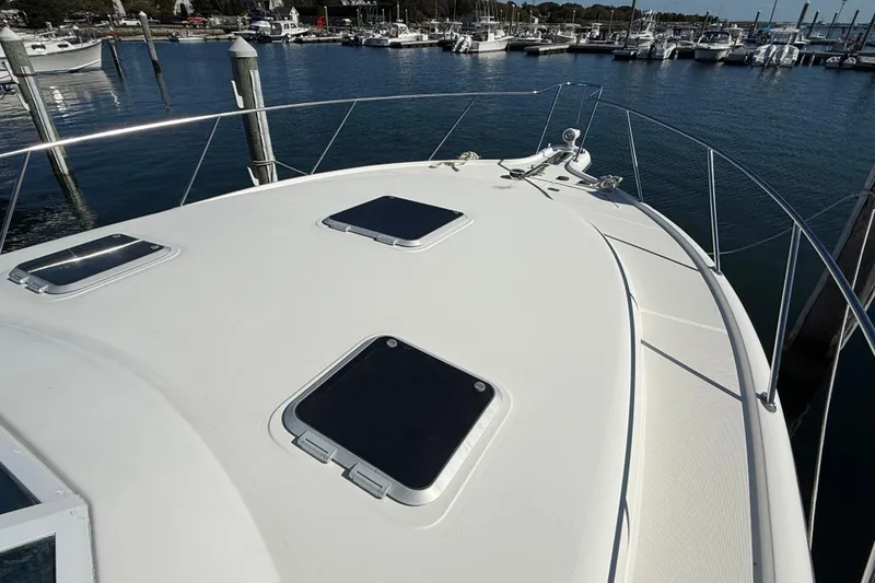 Slide: The Image of 2003 Tiara Yachts 3500 Open boat deck with hatches, docked in marina. - 10