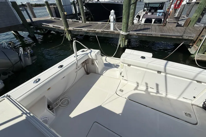 Slide: The Image of 2003 Tiara Yachts 3500 Open boat docked, showcasing spacious deck and marina setting. - 13