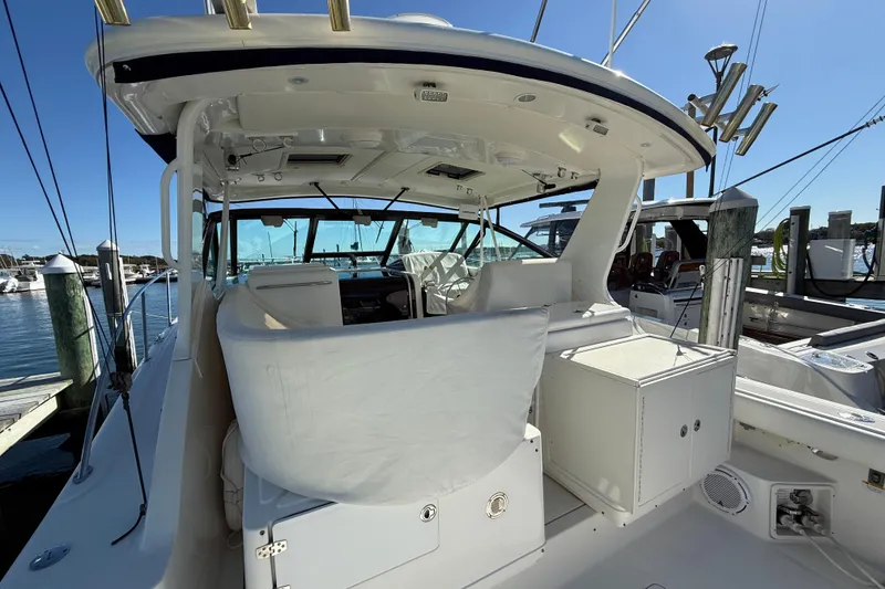Slide: The Image of 2003 Tiara Yachts 3500 Open at dock, showcasing spacious cockpit and helm area. - 15