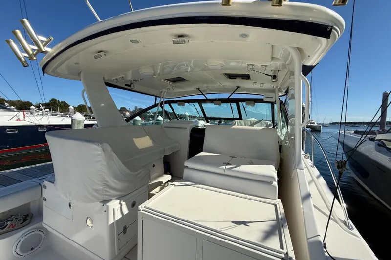 Slide: The Image of 2003 Tiara Yachts 3500 Open, spacious deck view, docked at marina under clear blue sky. - 16