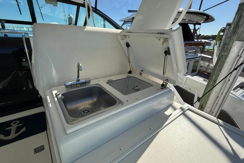 Slide: The Image of 2003 Tiara Yachts 3500 Open boat with open sink and storage area. - 17
