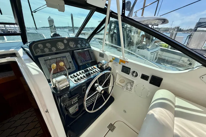 Slide: The Image of 2003 Tiara Yachts 3500 Open helm with navigation instruments and steering wheel. - 20