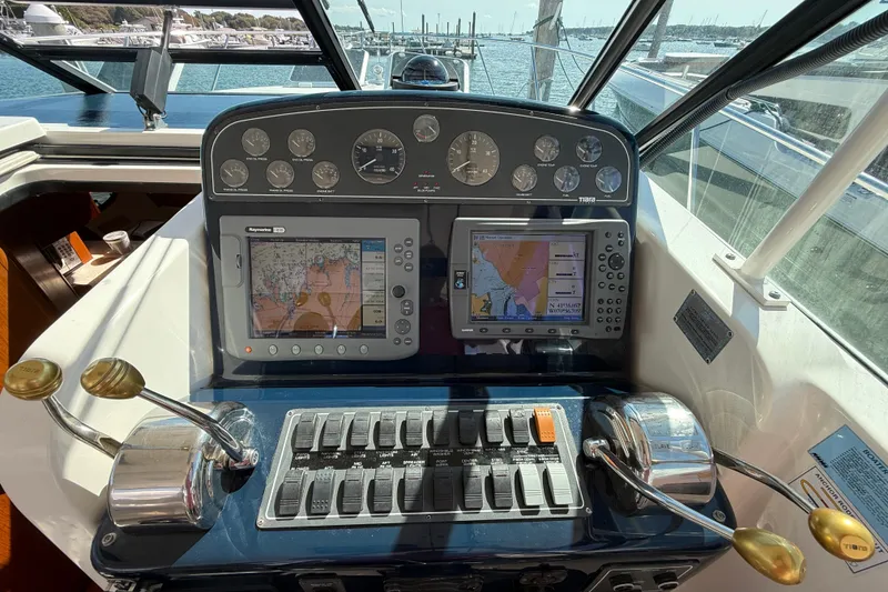 Slide: The Image of Helm of 2003 Tiara Yachts 3500 Open with navigation displays and controls. - 21