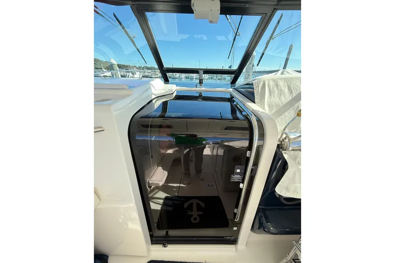 Slide: The Image of 2003 Tiara Yachts 3500 Open cabin entrance with glass door and marina view. - 22
